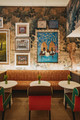 Bench upholstered in Hotline Indoor Woven Orange by Kit Kemp at Warren Street Hotel, featuring eclectic patterns and rich textures.
